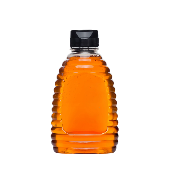 Bottle of honey with a black cap on a white background